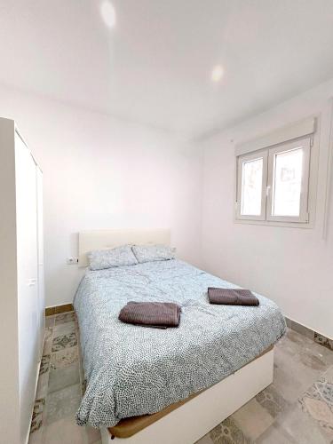 a bedroom with a bed with two pillows on it at Gran Teatro Falla in Cádiz