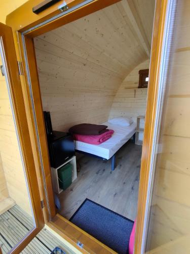 a small room with a bed in a tiny house at Camping du Moulin de Thoard in Thoard