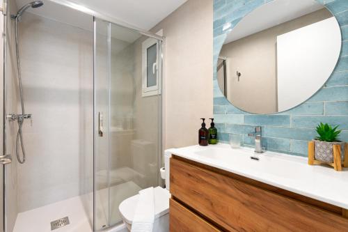 a bathroom with a shower and a sink and a mirror at Lodging Apartments Beach Studio P1 in Barcelona