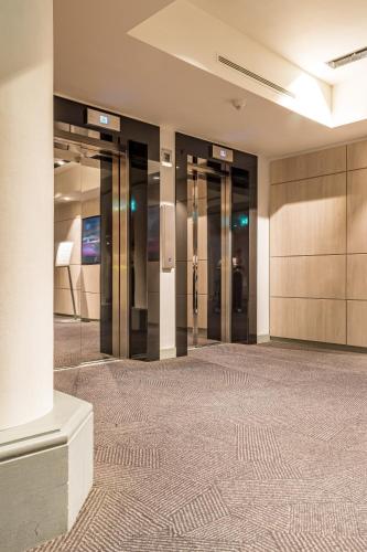 an empty lobby with elevators in a building at The Marble Arch Hotel, by Thistle in London