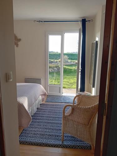 a bedroom with a bed and a door with a window at Cocooning au Saut du Loup in Lavergne