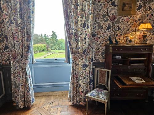 a room with a window and a chair and a desk at Château de Craon in Craon