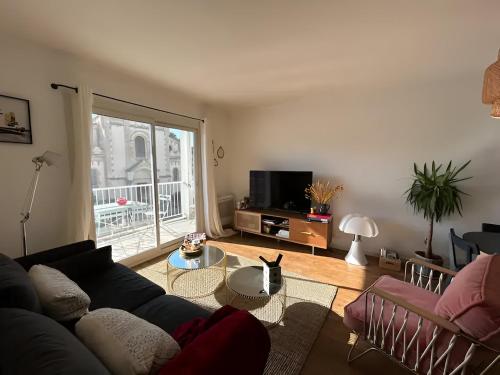 a living room with a couch and a tv at Appartement Unique - Roucas Blanc in Marseille