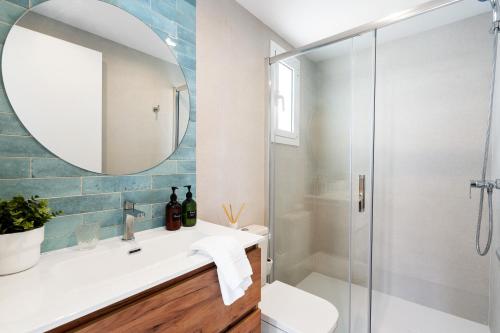 a bathroom with a shower and a sink and a mirror at Lodging Apartments Barceloneta Beach Studio 42 in Barcelona