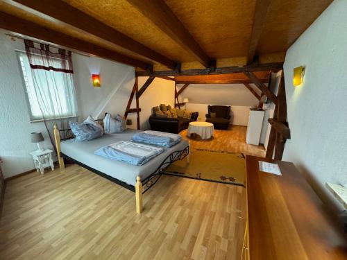 a bedroom with a bed and a living room at Lausitzhof in Hoyerswerda