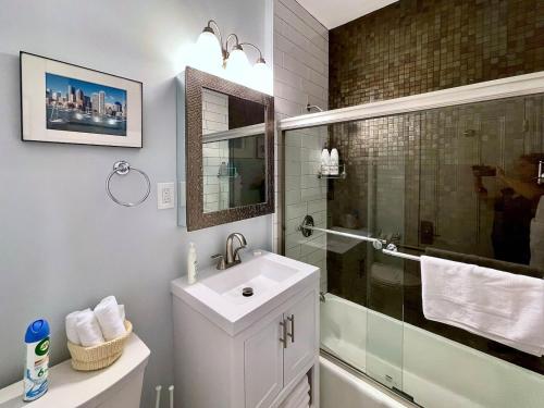 a white bathroom with a sink and a shower at Renovated 4bed 15 Bath, Mit, Harvard,hospitals in Cambridge