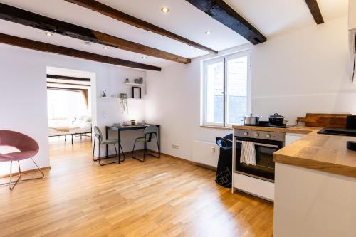 a kitchen and dining room with a table and chairs at Fachwerk Boutique-Hotel 1 in Hattingen