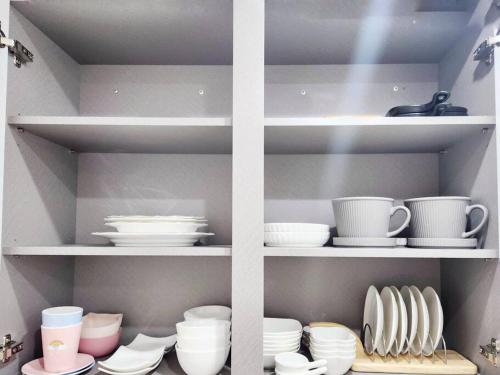 a shelf filled with dishes and cups and plates at Home Woodsage in Seoul