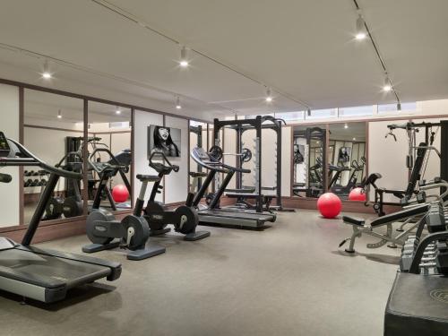 a gym with a lot of treadmills and exercise bikes at H10 Porto Poniente 4* Sup in Benidorm