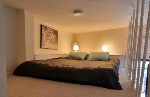 a bedroom with a large bed with two pillows at Tivat lovely cosy studio in Tivat