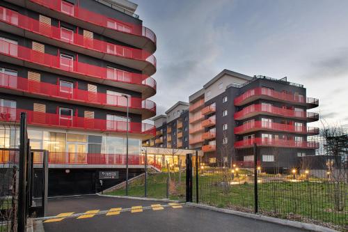 um par de edifícios altos ao lado de um parque de estacionamento em Domitys l'Esquisse em Valenciennes