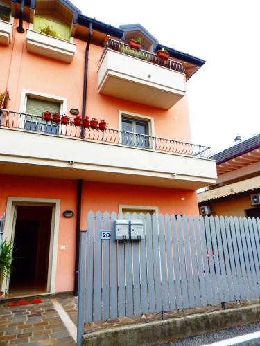 a house with a blue fence in front of it at Appartamenti Jamaica in Sirmione
