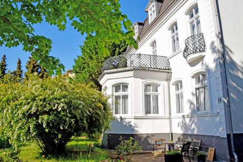 a white building with a balcony on it at Villa im Ostseebad Baabe in Baabe