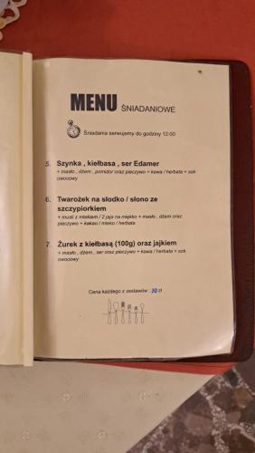 a menu in a book sitting on a table at Zajazd-restauracja Zyga in Iwkowa