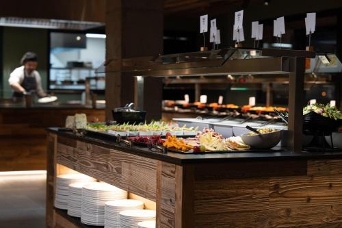 a buffet line with a lot of food on at Hotel AnyosPark Mountain & Wellness Resort in Anyós