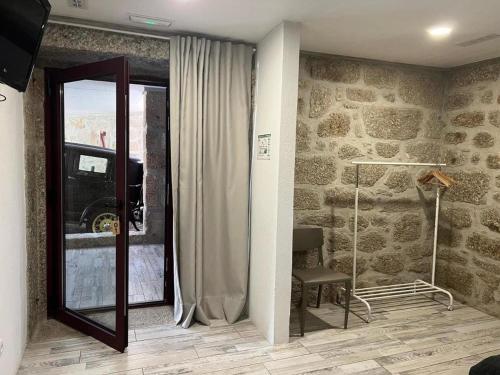 a room with a mirror and a window and a chair at Charming Villa with Pool and Jacuzzi - Terras de Bouro in Terras de Bouro