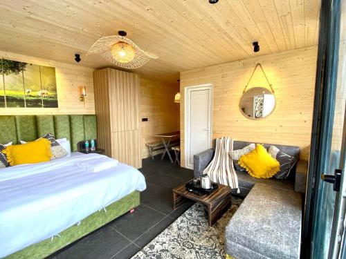 a bedroom with a large bed and a couch at The Kiana's in Mussoorie