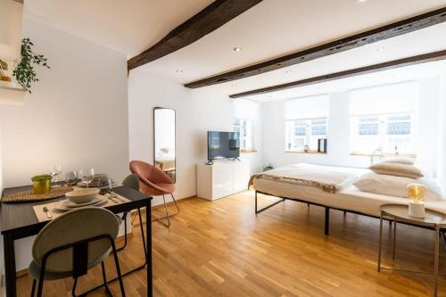 a bedroom with a bed and a table and chairs at Fachwerk Boutique-Hotel 2 in Hattingen