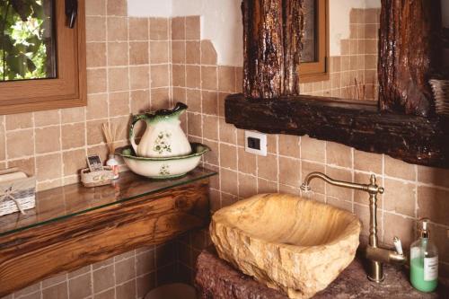 a bathroom with a wooden sink and a vase on a counter at Cueva los Almendros in Vilaflor