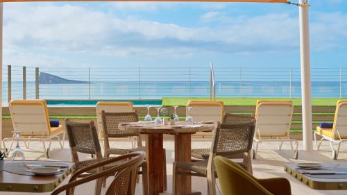 a table and chairs with a view of the ocean at H10 Porto Poniente 4* Sup in Benidorm