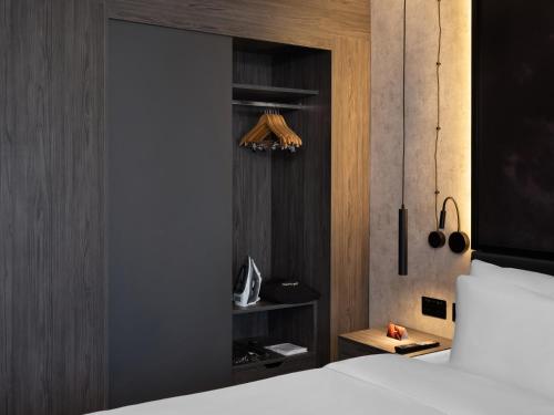 a bedroom with a bed and a wooden wall at Radisson RED London Gatwick Airport in Crawley