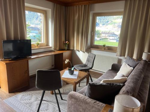 a living room with a couch and two chairs at Apart Bergblick in Ramsau im Zillertal