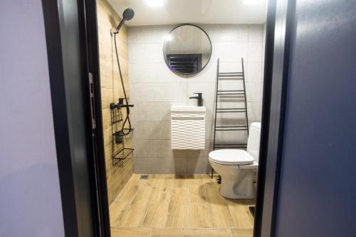 a bathroom with a toilet and a mirror at Narnia LOFT in Kavarna