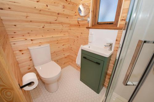a small bathroom with a toilet and a sink at Glamping Pod 1 Comfort in Scarborough