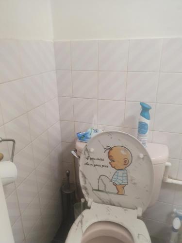 a bathroom with a toilet with a drawing on the seat at Queensgate centre in Stifford