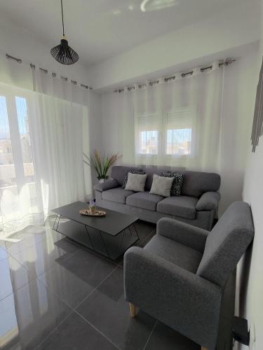 a living room with a couch and a coffee table at Margarita in Chania