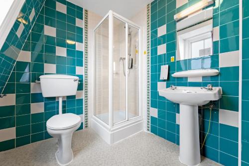 a bathroom with a toilet and a sink at The Royal Hotel Whitby in Whitby