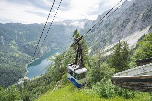 a gondola ride up a mountain in the mountains at Appartements Pension Elfi in Gosau
