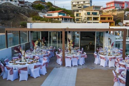 a group of tables set up for a banquet at Ouril Mindelo in Mindelo