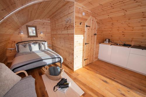 a room with a bed and a kitchen in a cabin at Glamping Pod 5 Shelter in Scarborough