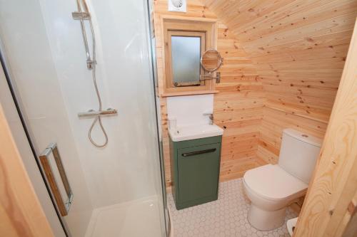 a small bathroom with a toilet and a sink at Glamping Pod 5 Shelter in Scarborough