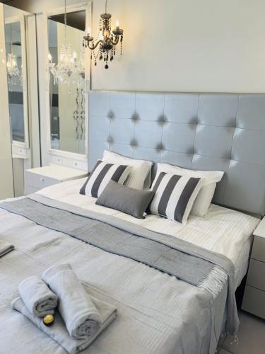 a bedroom with a large bed with towels on it at Costa Adeje Orlando Tenerife Sea View - Pool - AC in Adeje