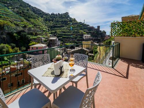 a table and chairs on a balcony with a view at Macaia Family Apartment with AC in Vernazza