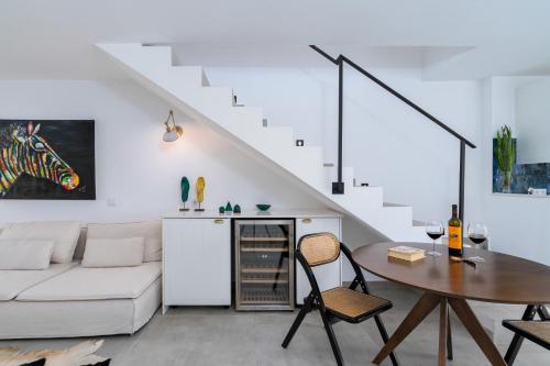 a living room with a white couch and a table at Casa Baco- Cozy House City Center in Lagoa