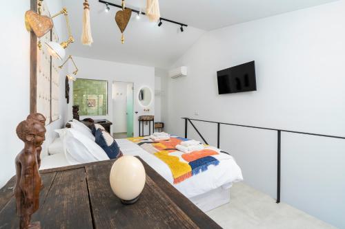 a bedroom with a bed and a table at Casa Baco- Cozy House City Center in Lagoa