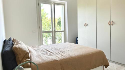 a bedroom with a bed and a window at S334 - Sirolo, meraviglioso trilocale panoramico in Sirolo