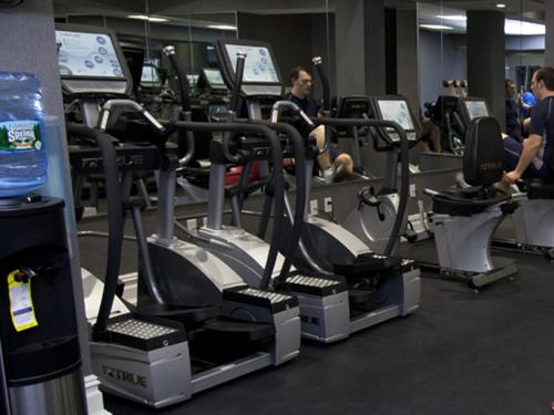 a gym with people exercising on tread machines at The Manhattan Club in New York