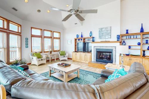 a living room with a leather couch and a fireplace at Lapha Amanzi #6-PA in Avon