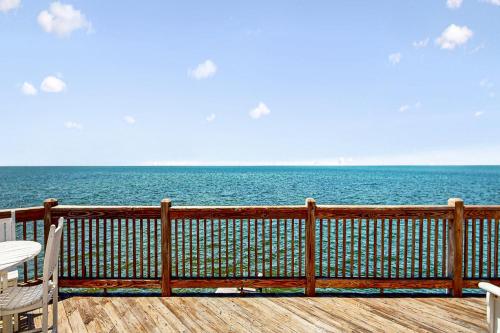 a wooden deck with a view of the ocean at Lapha Amanzi #6-PA in Avon