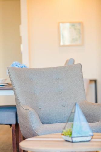 a blue chair with a toy boat on a table at Central Location 1BR APT w City view South BNE in Brisbane