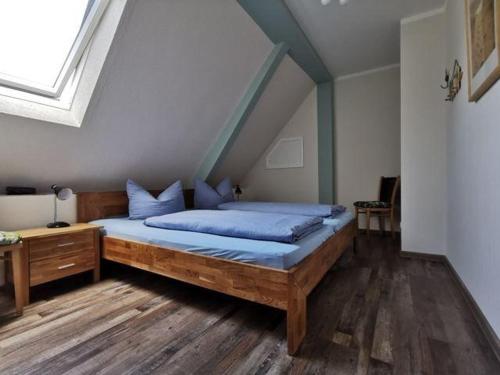 a bedroom with a large bed with blue sheets at Ferienwohnung-Apfelbluete in Presen