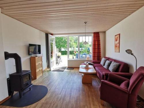 a living room with a couch and a stove at Doppelhaushaelfte-Klatschmohn in Presen
