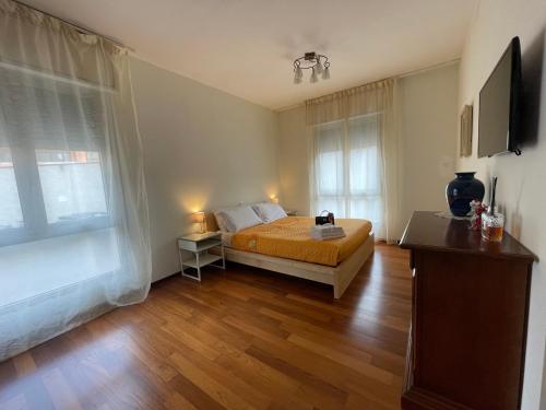 a bedroom with a bed and two windows at Forte Marghera 119 in Venice