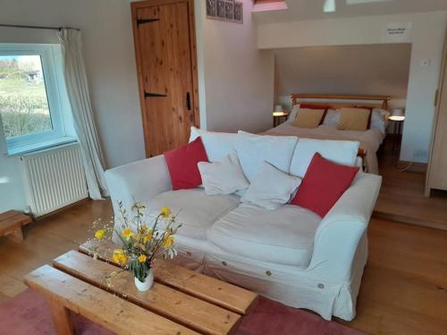 a living room with a couch and a bed at The Barn, Poplar Farm in York