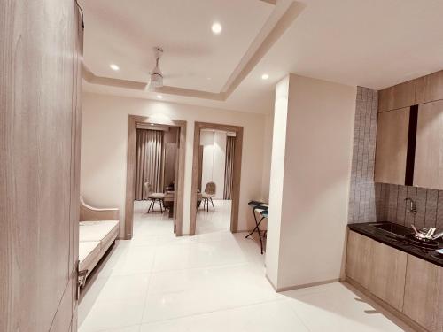 a room with a kitchen and a dining room at The Lodgers 2 BHK Serviced Apartment Near Artemis Hospital Sector 57 Gurgaon - Nearest Metro Station Sector 54 Chowk in Gurgaon