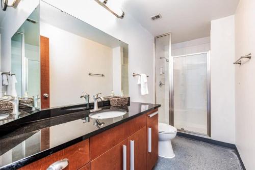 a bathroom with a sink and a toilet at STUNNING Architect loft by CozySuites in Saint Louis